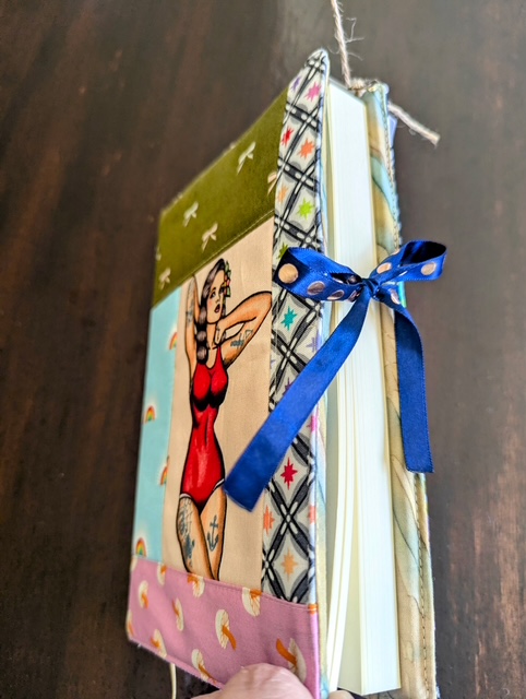 Woman patchwork book sleeve handmade by Salty Bee Threads